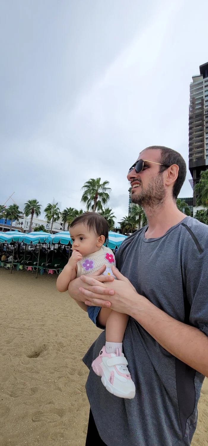 Todd and his daughter enjoying a day at the beach in Thailand