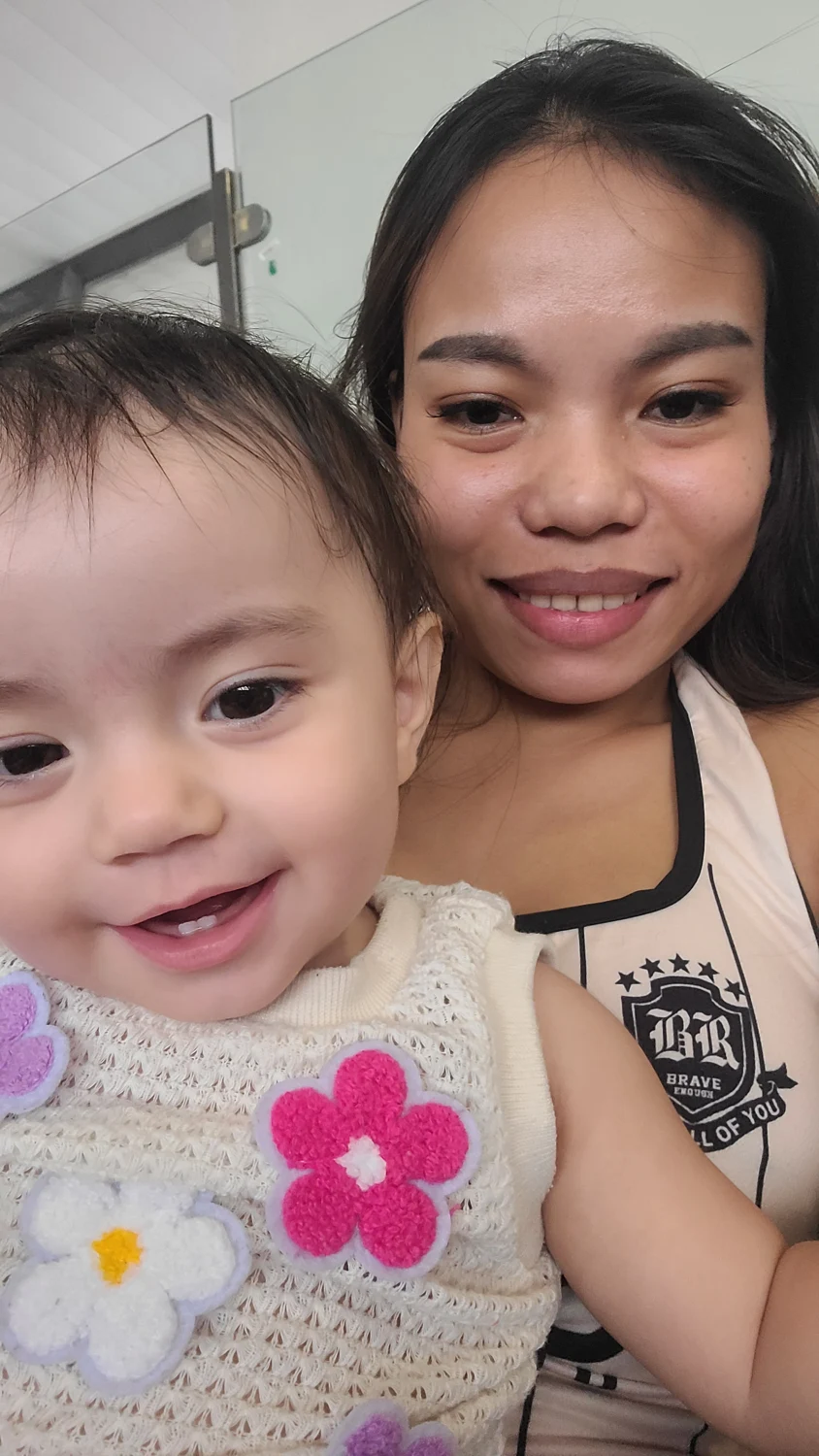 Todd’s wife and daughter smiling together in Thailand